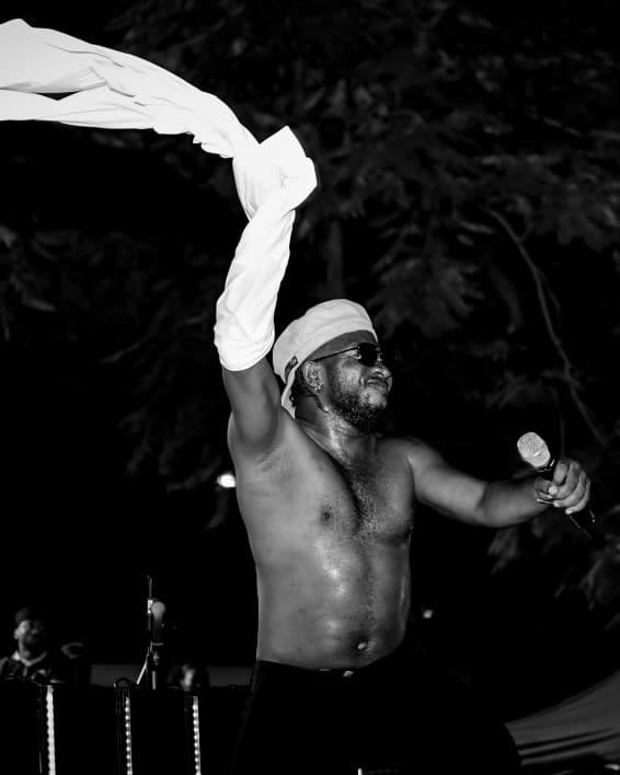 Artist on stage swinging a towel over the crowd